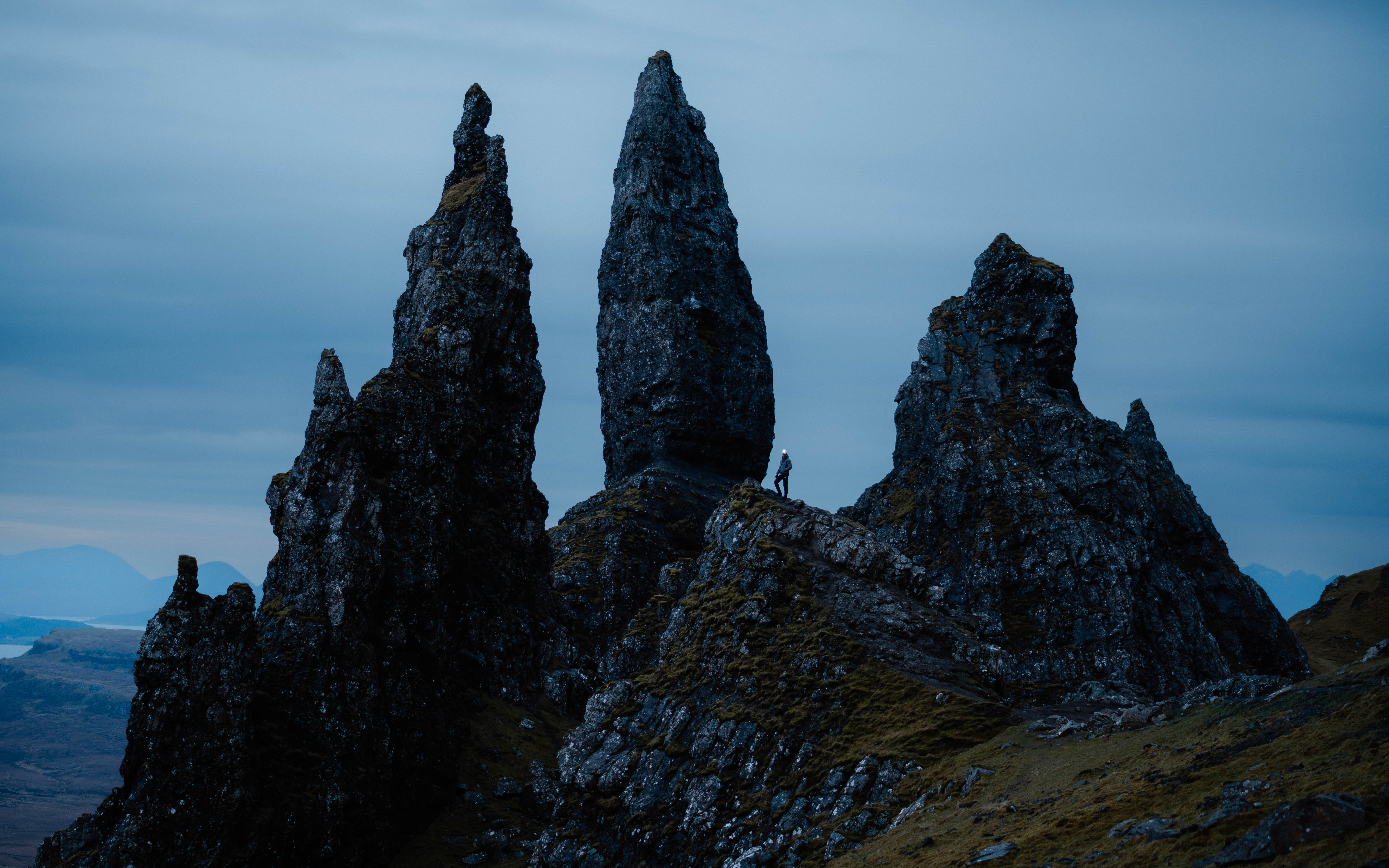 Three pointed rocks with a small figure standing next to them